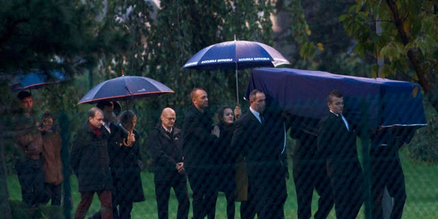 A coffin bearing the body of one of the two French radio journalists killed in Mali is carried at Roissy Charles de Gaulle Airport in Roissy, north of Paris, Tuesday, Nov. 5, 2013. The slayings of Ghislaine Dupont, 57, a senior correspondent, and Claude Verlon, 55, a production technician, stunned France and were an unheard of assault on Western journalists in Mali, where a French-led military operation this year aimed to clear out Islamic extremists who had taken over the vast north. (AP Photo/Thibault Camus)