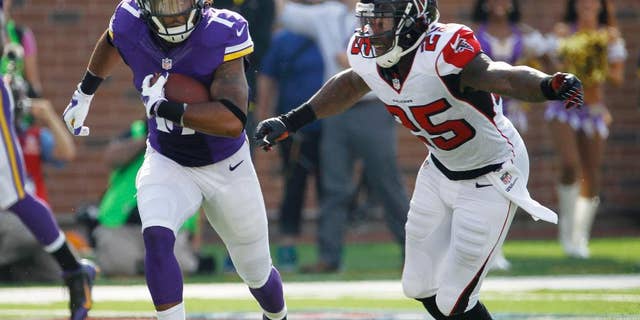 Minnesota Vikings cornerback Xavier Rhodes, left, breaks up a pass intended for Atlanta Falcons wide receiver Julio Jones (11) during the second half of an NFL football game, Sunday, Sept. 28, 2014, in Minneapolis. (AP Photo/Ann Heisenfelt)