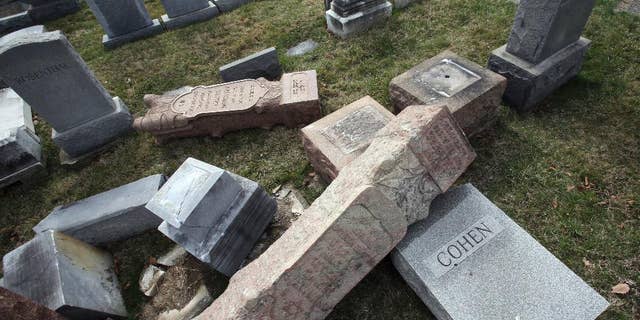 FILE - In this Monday, Feb. 27, 2017 file photo,toppled and damaged headstones rest on the ground at Mount Carmel Cemetery in Philadelphia. The Anti-Defamation League found an increase in cases of anti-Semitic intimidation and vandalism in 2016, evidence that anti-Jewish bias intensified during the election. (AP Photo/Jacqueline Larma)