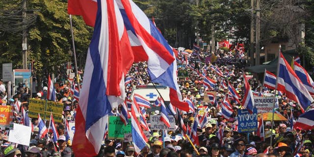FILE - In this Jan. 18, 2014 file photo, Thai anti-government protesters march on a street during a rally in Bangkok, Thailand. Thailand's military-installed prime minister defended a new law that places tight restrictions on public gatherings and warned Thursday, Aug. 13, 2015 it will be strictly enforced. Human rights groups have voiced concern about the Public Assembly Act, which took effect Thursday, and its stiff penalties. (AP Photo/Sakchai Lalit, File)