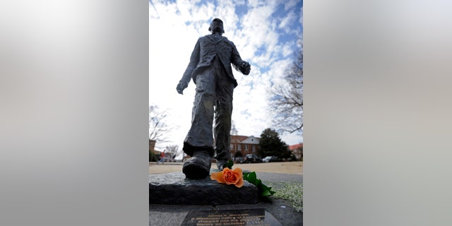 A flower is seen on the James Meredith statue at the University of Mississippi in Oxford, Miss., Tuesday, Feb. 18, 2014. Campus police at the University of Mississippi are checking video surveillance footage in the area around a statue of James Meredith that was found sullied Sunday morning. (AP Photo/The Daily Mississippian, Thomas Graning)
