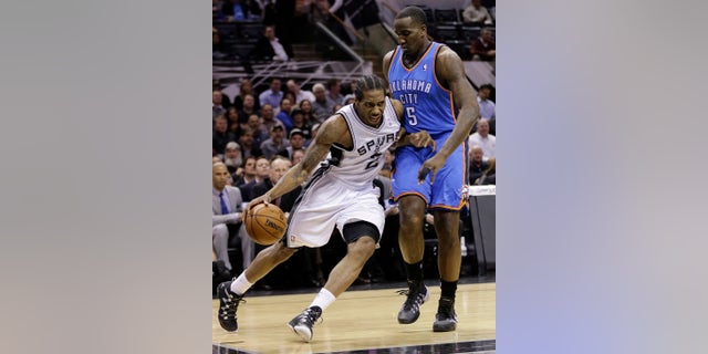 San Antonio Spurs' Kawhi Leonard (2) drives around Oklahoma City Thunder's Kendrick Perkins (5) during the first half of an NBA basketball game, Wednesday, Jan. 22, 2014, in San Antonio. The Thunder won 111-105. (AP Photo/Eric Gay)
