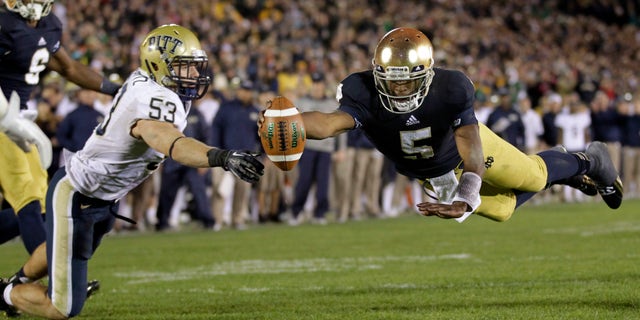 FILE - In this Nov. 3, 2012 file photo, Notre Dame quarterback Everett Golson, right, dives into the end zone in front of Pittsburgh linebacker Joe Trebitz for a two-point conversion to tie the score late in the fourth quarter of an NCAA college football game in South Bend, Ind. Golson is expecting a lot more of himself and the Fighting Irish offense next season. (AP Photo/Michael Conroy, FILE)