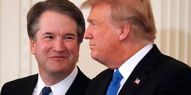 Supreme Court nominee Judge Brett Kavanaugh looks at U.S. President Donald Trump in the East Room of the White House in Washington, U.S., July 9, 2018. REUTERS/Jim Bourg