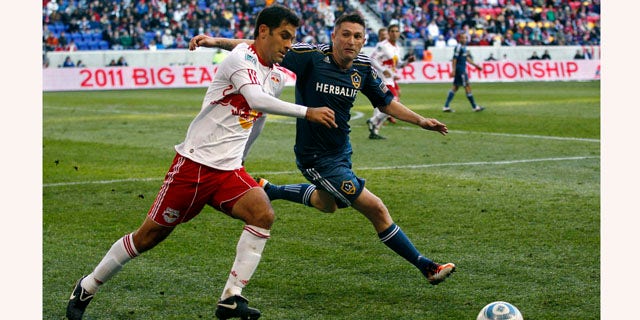 New York Red Bulls defender Rafa Marquez, left, of Mexico, tries to get the ball away from Los Angeles Galaxy forward Robbie Keane (14), of Ireland, during the second period of an MLS soccer match Sunday, Oct. 30, 2011, Newark, N.J. Galaxy won 1-0. (AP Photo/Mel Evans)