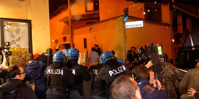 Oct. 15, 2013: Police in riot gear go after protesters after scuffles broke out outside the Society of St. Pius X, a schismatic Catholic group, where funeral of Nazi war criminal Erich Priebke was scheduled to take place, in Albano Laziale, on the outskirts of Rome.