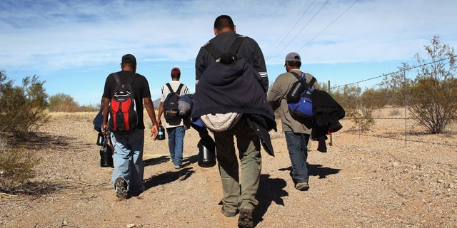 TOHONO O'ODHAM NATION, AZ - JANUARY 19: Undocumented Mexican immigrants walk through the Sonoran Desert after illegally crossing the U.S.-Mexico border border on January 19, 2011 into the Tohono O'odham Nation, Arizona. The immigrants said they had wandered the desert lost for a week after crossing from Mexico into the vast Indian reservation at night. Exhausted, they requested the Border Patrol to pick them up and take them to the U.S.-Mexico border, from where they would return to their homes in the Mexican state of Sonora. They had come, they said, to reach Phoenix and find work in construction or landscaping. All said they had worked in Arizona before. (Photo by John Moore/Getty Images)