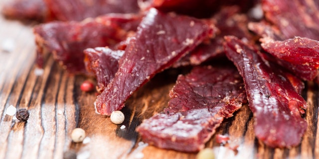 Portion of Beef Jerky on vintage wooden background
