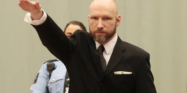 Anders Behring Breivik raises his right hand at the start of his appeal case in Borgarting Court of Appeal at Telemark prison in Skien, Norway, Tuesday, Jan. 10, 2017. Norwegian mass murderer Anders Behring Breivik walked quietly into a courtroom at a high security prison Tuesday, making a neo-Nazi salute, as judges began reviewing a government appeal against a ruling that his solitary confinement was inhumane and violated human rights. (Lise Aaserud/NTB Scanpix via AP)