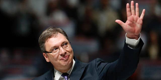 FILE - In this Thursday, April 21, 2016 file photo, Serbian Prime Minister-designate, Aleksandar Vucic waves to his supporters during a pre-election rally in Belgrade, Serbia. Vucic has canceled his visit to Brussels and separate talks with American officials after reports in a pro-government newspaper that the EU and U.S. ambassadors to Serbia are fueling street protests against his rule, the state TV said Monday, June 13, 2016. (AP Photo/Darko Vojinovic, File)