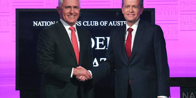 FILE - In this May, 29, 2016 file photo, Australian Prime Minister Malcolm Turnbull, left, and opposition leader Bill Shorten shake hands as they arrive for the leaders' debate at the National Press Club in Canberra. Turnbull said Tuesday, June 7 that he had reached an agreement with Facebook and News Corp. Australia to stream the debate early next week in a bid to reach more voters. Shorten later agreed to participate. (Tracey Nearmy/Pool Photo via AP, File)