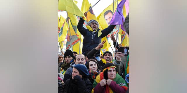 Pro-Kurdish demonstrators protest against Turkish president Recep Tayyip Erdogan and the political repression that followed July's failed military coup, in Cologne, Germany Saturday, Nov. 12, 2016. People showing flags of detained Kurdistan Workers Party, PKK , leader Abdullah Ocalan. (AP Photo/Martin Meissner)