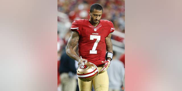 San Francisco 49ers quarterback Colin Kaepernick (7) walks on the field during the fourth quarter of an NFL football game against the Chicago Bears in Santa Clara, Calif., Sunday, Sept. 14, 2014. (AP Photo/Tony Avelar)