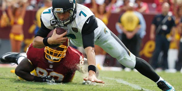Jacksonville Jaguars quarterback Chad Henne (7) is sacked by Washington Redskins defensive end Chris Baker (92) during the second half of an NFL football game Sunday, Sept. 14, 2014, in Landover, Md. The Redskins won 41-10. (AP Photo/Evan Vucci)