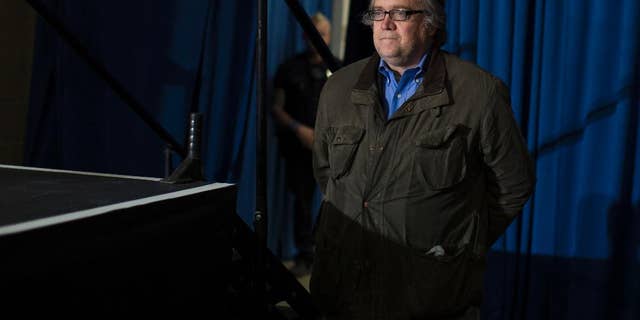 FILE - In this Saturday, Nov. 5, 2016, file photo, Stephen Bannon, campaign CEO for Republican presidential candidate Donald Trump, looks on as Trump speaks during a campaign rally in Denver. Following the installation of Breitbart's chief executive, Bannon, to a top job in President-elect Trump's administration, the news organization in its infancy when Barack Obama took office has big expansion plans and the goal of being the best source of news on the new administration. (AP Photo/Evan Vucci, File)