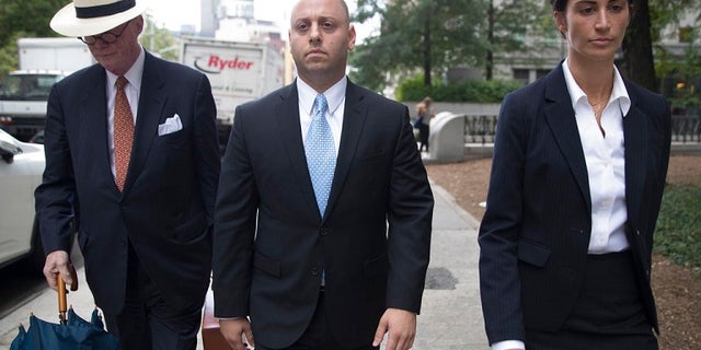 Adam Skelos, center, leaves federal court, Tuesday, July 17, 2018, in New York City.