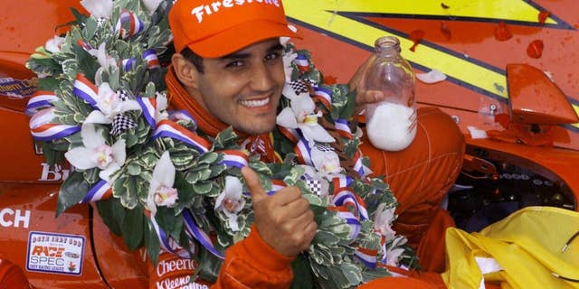 FILE - In this May 28, 2000 file photo, Juan Pablo Montoya of Colombia gives a thumbs-up while holding a bottle of milk after winning the 84th edition of the Indianapolis 500 auto race at Indianapolis Motor Speedway. (AP Photo/Michael Conroy, File)