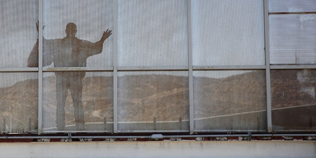 TIJUANA, MEXICO - OCTOBER 02: A deported immigrant pauses while crossing back into Mexico after being deported by U.S. immigration authorities on October 2, 2013 to Tijuana, Mexico. Despite the U.S. federal shutdown, most border agents have been categorized as essential personnel and continue working. (Photo by John Moore/Getty Images)