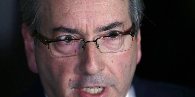FILE - In this May 5, 2016 file photo, Brazil's President of the Chamber of Deputies Eduardo Cunha speaks during a press conference in Brasilia, Brazil. Cunha, the man who led efforts to impeach Brazil's suspended President Dilma Rousseff, has resigned as speaker of the lower house of congress. He said he hopes it ends the chaos in Brazil's congress. Judges already had suspended Cunha over allegations of obstructing justice and holding Swiss bank accounts worth millions of dollars in bribe. (AP Photo/Eraldo Peres, File)