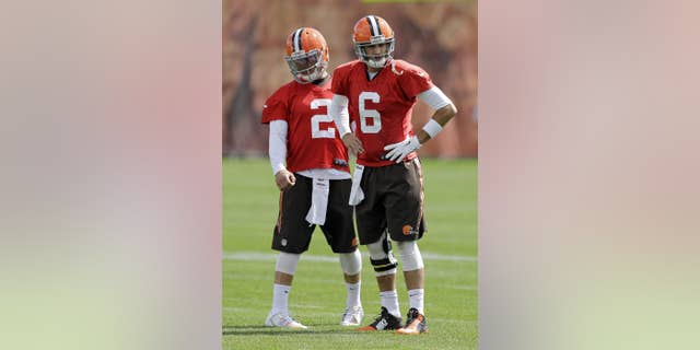 Cleveland Browns quarterback Brian Hoyer (6) and Johnny Manziel (2) wait for a passing drill during practice at the NFL football team's facility in Berea, Ohio, Wednesday, Sept. 17, 2014. Hoyer, who drove 85 yards to set up the game-winning field goal Sunday against the New Orleans Saints, showed that the Browns are his team and Manziel has to watch and learn, for now. (AP Photo/Mark Duncan)