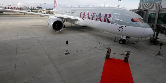 FILE -- In this Nov. 4, 2015  file photo, a Boeing 787 airplane purchased by Qatar Airways is shown during a delivery ceremony in Everett, Wash. Qatar Airways, one of the Middle East's biggest carriers, announced Sunday, July 10, 2016, net profits of $445 million in 2016, up from $103 million the previous year. It says the airline's revenue rose from $9.3 billion in 2015 to $9.6 billion. Qatar Airways Group Chief Executive Akbar Al-Baker said it was the 19-year-old airline's best fiscal year to date. (AP Photo/Ted S. Warren, File)
