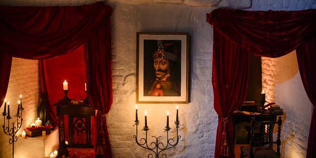 In this picture taken Oct. 9, 2016, a portrait of Vlad the Impaler is hung on a wall in Bran Castle, in Bran, Romania.  (AP Photo/Andreea Alexandru)