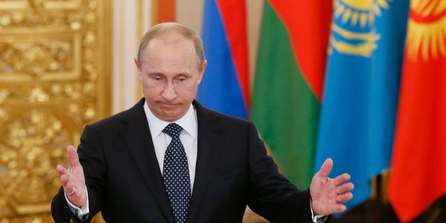 Russia's President Vladimir Putin welcomes the leaders of member countries of the Collective Security Treaty Organization (CSTO) in Moscow, Wednesday, Dec. 19, 2012. (AP Photo/Yuri Kochetkov, Pool)