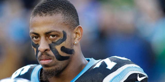 FILE - In this Dec. 15, 2013, file photo, Carolina Panthers' Greg Hardy watches before an NFL football game against the New York Jets in Charlotte, N.C. The Panthers announced Wednesday, Sept. 17, 2014, that they've placed Hardy on the exempt-commissioner's permission list, meaning the Pro Bowl defensive end has been removed from the team's active roster until his domestic violence case is resolved.  (AP Photo/Bob Leverone, File)