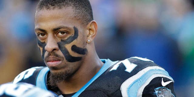 FILE - In this Dec. 15, 2013, file photo, Carolina Panthers' Greg Hardy watches before an NFL football game against the New York Jets in Charlotte, N.C. The Panthers announced Wednesday, Sept. 17, 2014, that they've placed Hardy on the exempt-commissioner's permission list, meaning the Pro Bowl defensive end has been removed from the team's active roster until his domestic violence case is resolved. (AP Photo/Bob Leverone, File)