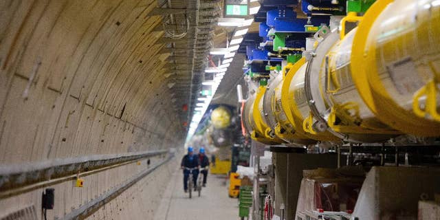 FILE - In this Feb. 18, 2015 file photo employees ride their bicycles inside the particle accelerator tunnel of the X-ray laser-project European XFEL on the outskirts of Hamburg, Germany. Researchers said Wednesday, April 19, 2017 they have reached a significant milestone on the path to beginning scientific operations later this year. (Daniel Bockwoldt/dpa via AP, file)