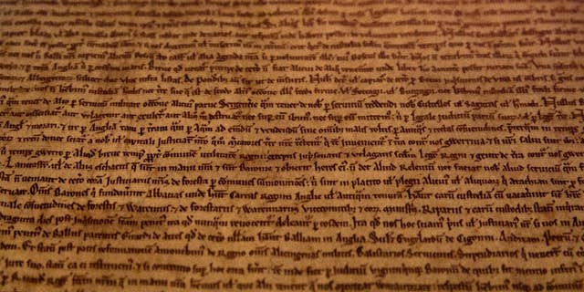 A detail of the Salisbury Magna Carta one of the four original surviving Magna Carta manuscripts that have been brought together by the British Library for the first time, on display at the library during a media preview in London in 2015. The document established the timeless principle that no individual, even a monarch, is above the law. (AP Photo/Alastair Grant)