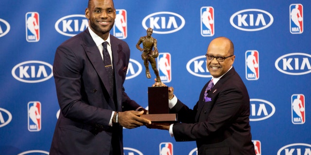 Miami Heat's LeBron James, left, and Kia Motors' Percy Vaughn pose for photos during an NBA basketball news conference, Sunday, May, 5, 2013, in Miami. James was formally announced as having won his fourth Most Valuable Player award Sunday. (AP Photo/J Pat Carter)