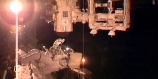 In this image taken from NASA television astronaut Andrew Feustel, prepares his tools that he will use to lubricate DEXTER platform's robotic arm during the second space walk early Sunday May 22, 2011.