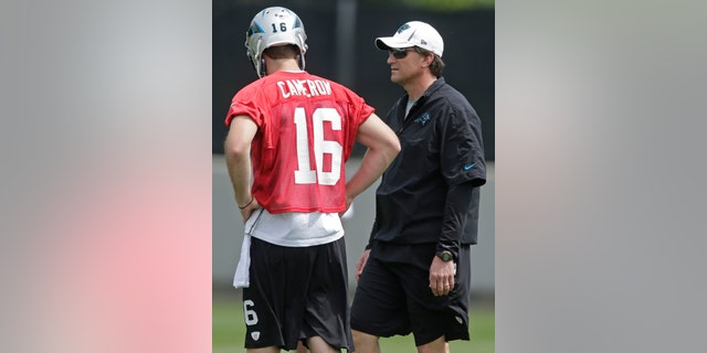 Carolina Panthers offensive coordinator Mike Shula, right, talks with quarterback Colby Cameron, left, during an NFL football rookie camp in Charlotte, N.C., Saturday, May 11, 2013. (AP Photo/Chuck Burton)