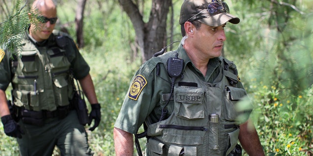 MCALLEN, TX - MAY 27: Border Patrol agents Robert Sanchez (L) and Hugo Moya search for undocumented immigrants believed to be hiding in the area along the north shore of the Rio Grande River which forms the border between the U.S. and Mexico May 27, 2010 near McAllen, Texas. During the 2009 fiscal year, 540,865 undocumented immigrants were apprehended entering the U.S. along the Mexican border. (Photo by Scott Olson/Getty Images) *** Local Caption *** Hugo Moya;Robert Sanchez