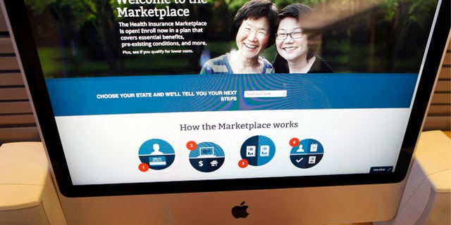 A man looks over the Affordable Care Act (commonly known as Obamacare) signup page on the HealthCare.gov website in New York in this October 2, 2013 photo illustration. The federal government's portal logged over 2.8 million visitors by afternoon October 2, largely in an attempt to sign up for Obamacare. REUTERS/Mike Segar (UNITED STATES - Tags: HEALTH SOCIETY POLITICS) - RTR3FIUH