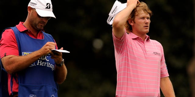 Brandt Snedeker, right, plans his tee shot on the 17th hole during the second round of the RBC Heritage golf tournament in Hilton Head Island, S.C., Friday, April 19, 2013. (AP Photo/Stephen Morton)