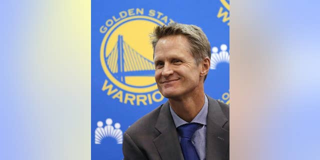 File - In this May 20, 2014, file photo, Golden State Warriors coach Steve Kerr smiles during a news conference in Oakland, Calif. With the Warriors set to open training camp Tuesday, Sept. 30, Kerr is counting on his work this offseason to pay off in practice. He has traveled the globe since being hired to replace coach Mark Jackson in May, believing all along that building personal relationships with players would wash away any uneasiness some had from his popular predecessor’s firing. (AP Photo/Ben Margot, File)