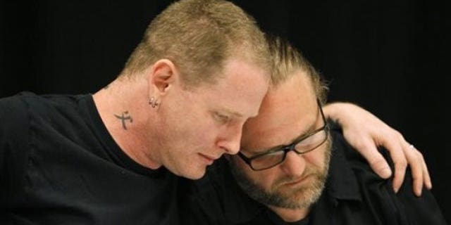 May 25: Slipknot lead singer Corey Taylor, left, reacts with band member Shawn Crahan after speaking about the death of bassist Paul Gray during a news conference in Des Moines, Iowa.