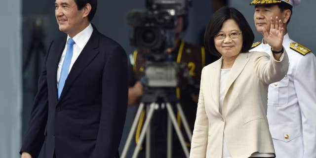 Taiwan's Tsai Ing-wen, right, waves beside incumbent President Ma Ying-jeou at the Presidential Office Building in Taipei, Taiwan, Friday, May 20, 2016. Taiwan inaugurated Tsai as its first female president on Friday, returning the pro-independence Democratic Progressive Party to power amid new concerns over increasingly fractious relations with Beijing and a flagging economy. (Minoru Iwasaki/Kyodo News via AP) JAPAN OUT, CREDIT MANDATORY