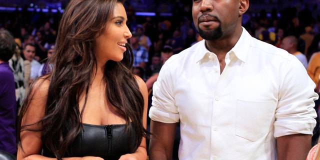Kim Kardashian and musician Kanye West watch the Los Angeles Lakers play the Denver Nuggets in Los Angeles, California May 12, 2012.