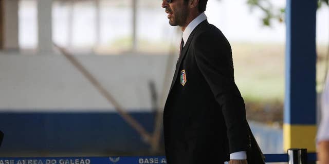 Italy's Gianluigi Buffon walks to his team's bus after arriving to the Galeao Air Base for the World Cup in Rio de Janeiro, Brazil, Friday, June 6, 2014. The Italian team will be based at a resort in Mangaratiba during the World Cup. (AP Photo/Leo Correa)