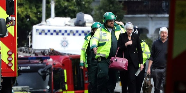 An injured woman is led away after an incident at Parsons Green underground station in London, Britain, September 15, 2017. REUTERS/Luke MacGregor - RC1F274B6C70