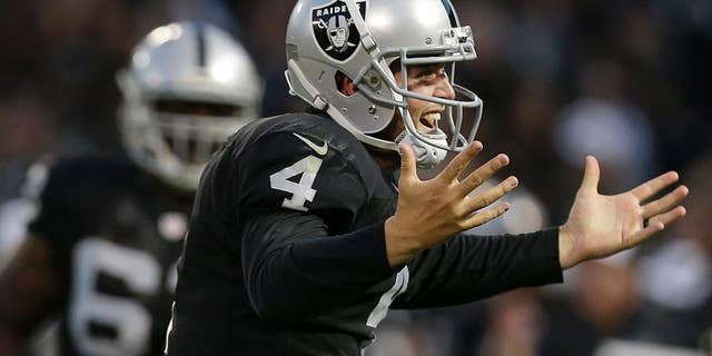 Oakland Raiders quarterback Derek Carr, right, celebrates after throwing a 20-yard touchdown pass to Mychal Rivera against the Seattle Seahawks during the first half of an NFL preseason football game in Oakland, Calif., Thursday, Aug. 28, 2014. (AP Photo/Marcio Jose Sanchez)