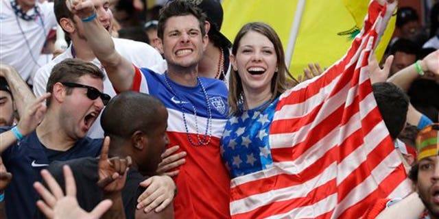 Fans celebrate as the United States scores a goal against Portugal while watching a World Cup soccer match, Sunday, June 22, 2014, in Orlando, Fla. (AP Photo/John Raoux)