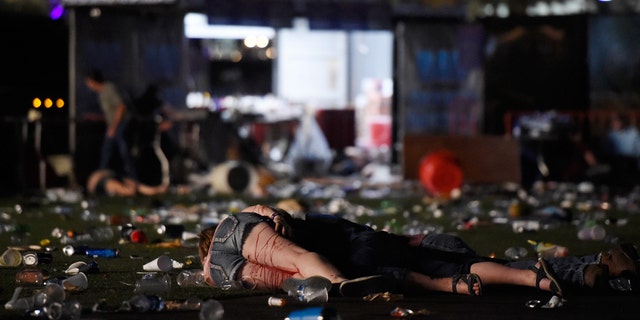 LAS VEGAS, NV - OCTOBER 01: (EDITORS NOTE: Image contains graphic content.) A person lies on the ground covered with blood at the Route 91 Harvest country music festival after apparent gun fire was heard on October 1, 2017 in Las Vegas, Nevada. There are reports of an active shooter around the Mandalay Bay Resort and Casino. (Photo by David Becker/Getty Images)