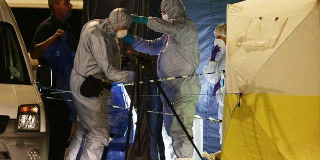 FILE - In this Aug. 4, 2016 file photo, police forensic officers at work in Russell Square, central London, after a knife attack. A teenager has admitted killing a retired Florida teacher and injuring five other people in a stabbing rampage near the British Museum in London. Somali-Norwegian Zakaria Bulhan, 19, pleaded guilty to manslaughter by diminished responsibility in the Aug. 3 slaying of 64-year-old Darlene Horton. He also pleaded guilty to five counts of wounding during a hearing Monday, Feb. 6, 2017 at London's Central Criminal Court. (Yui Mok/PA via AP, file)