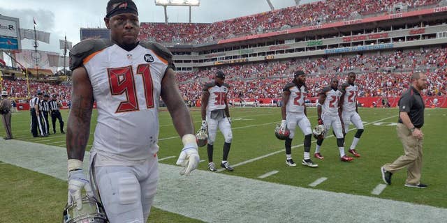 Tampa Bay Buccaneers defensive end Da'Quan Bowers (91) and leave the field during a weather warning in the second quarter of an NFL football game against the St. Louis Rams, Sunday, Sept. 14, 2014, in Tampa, Fla. (AP Photo/Phelan M. Ebenhack)