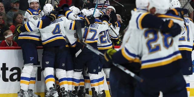 St. Louis Blues celebrate a 4-3 overtime win over the Minnesota Wild in Game 3 of an NHL hockey first-round Stanley Cup playoff series, Saturday, April 22, 2017, in St. Paul, Minn. (Anthony Souffle/Star Tribune via AP)