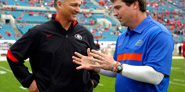 FILE - In this Oct. 29, 2011, file photo, Florida coach Will Muschamp, right, and Georgia coach Mark Richt talk before an NCAA college football game in Jacksonville, Fla. Georgia and Florida, teams that began the year with championship aspirations, have been ravaged by injuries and enter their annual Cocktail Party game at Jacksonville staring at the final gasp to make something of their disappointing seasons. (AP Photo/Stephen Morton, File)